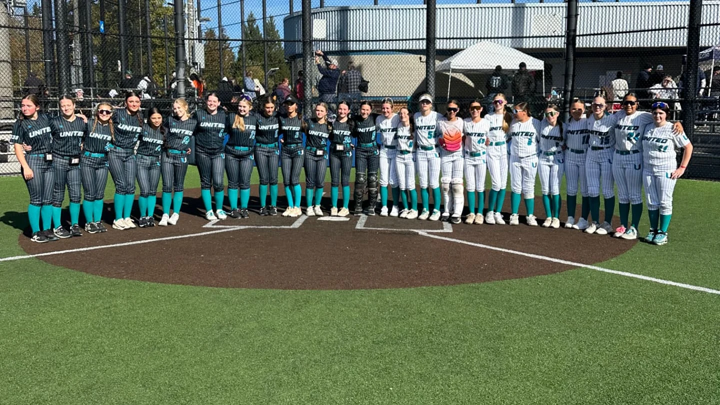 United Softball teams standing together on the softball field.